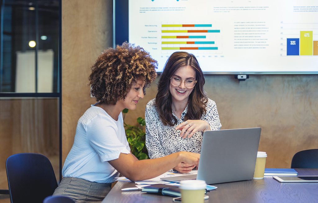 Colleagues working together at a laptop