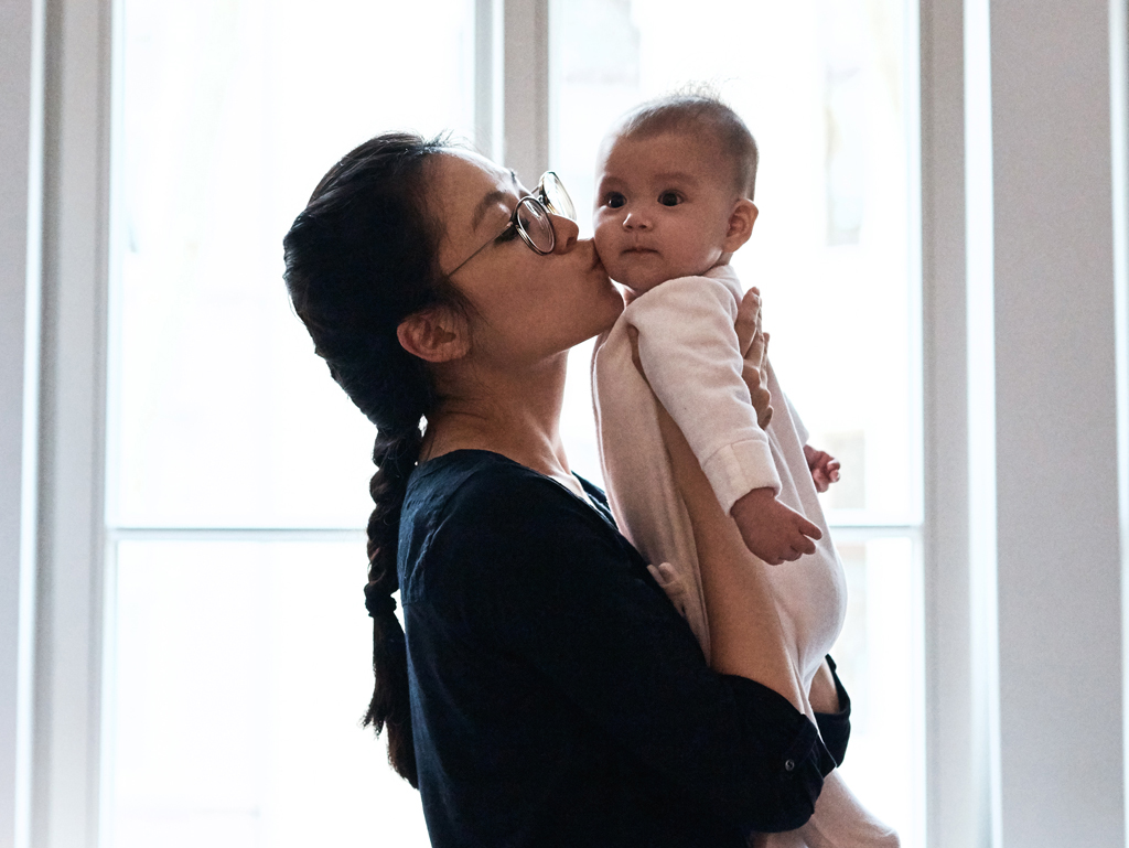 A mother spending time and bonding with her baby at home after giving birth