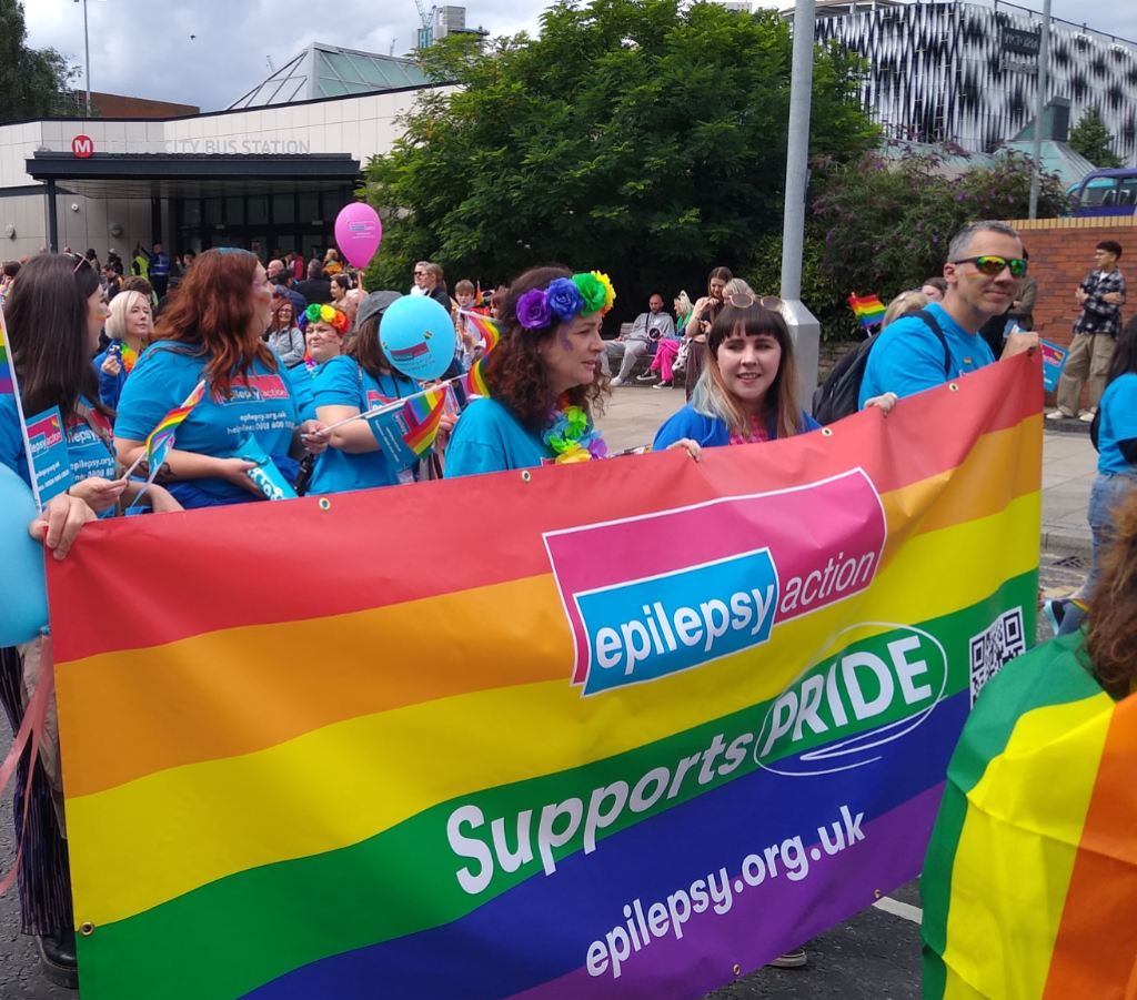 Epilepsy Action staff at Leeds pride holding rainbow banner