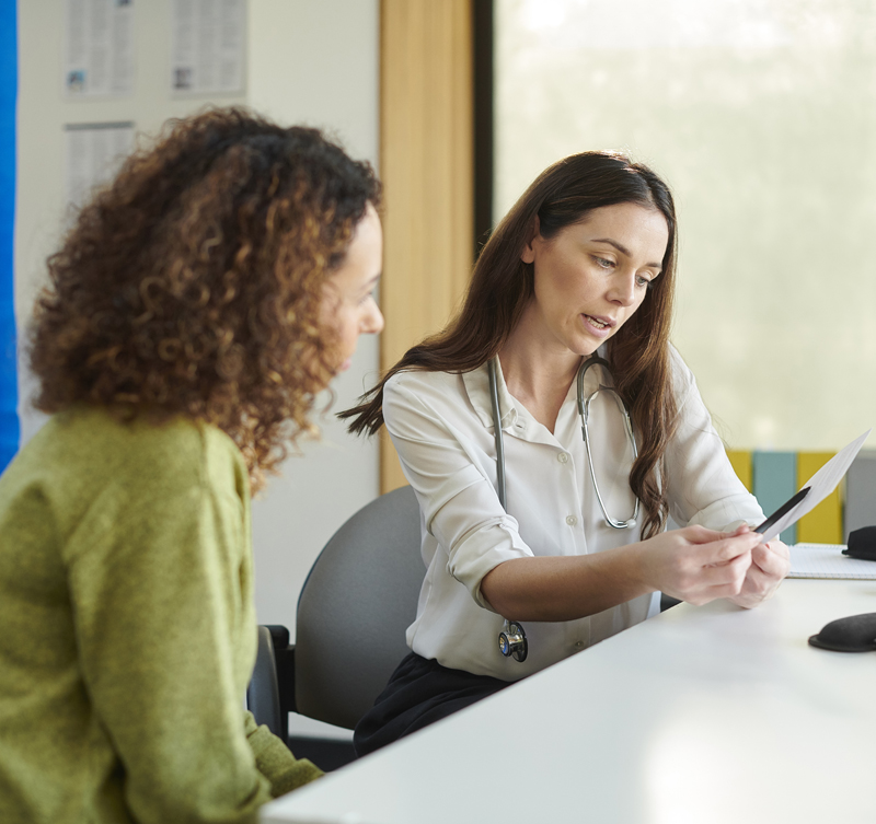 A woman discussing sodium valproate with her doctor