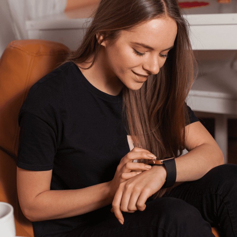 young woman looking at her smart watch