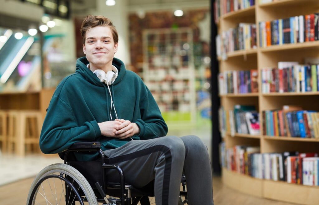 young man in a wheelchair at a library