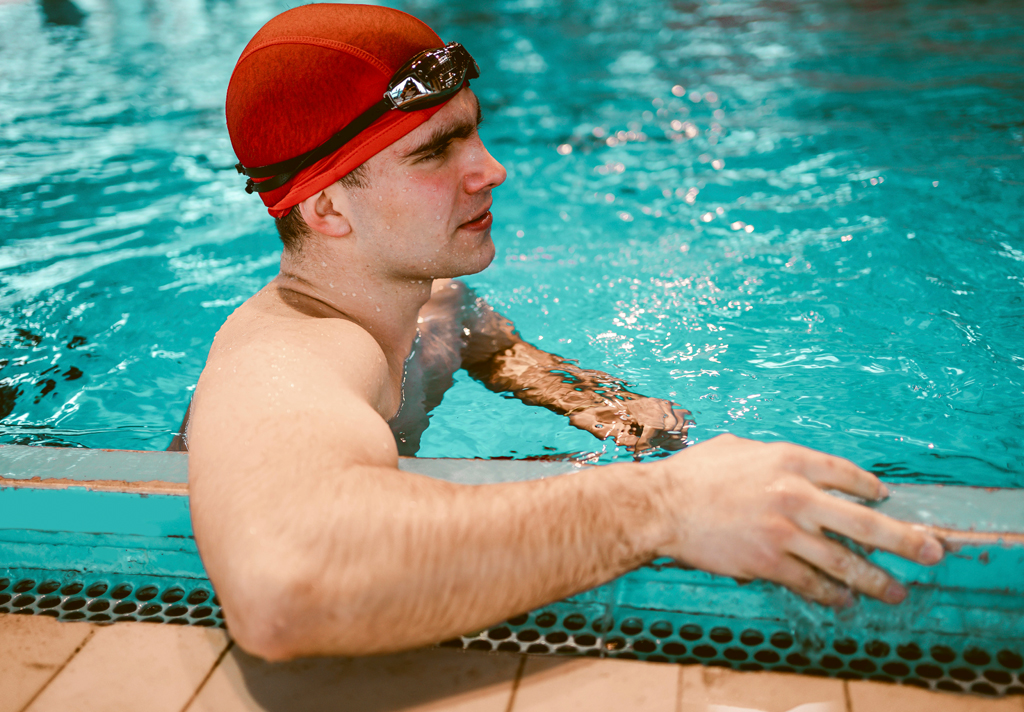 Man with epilepsy near the side of a pool