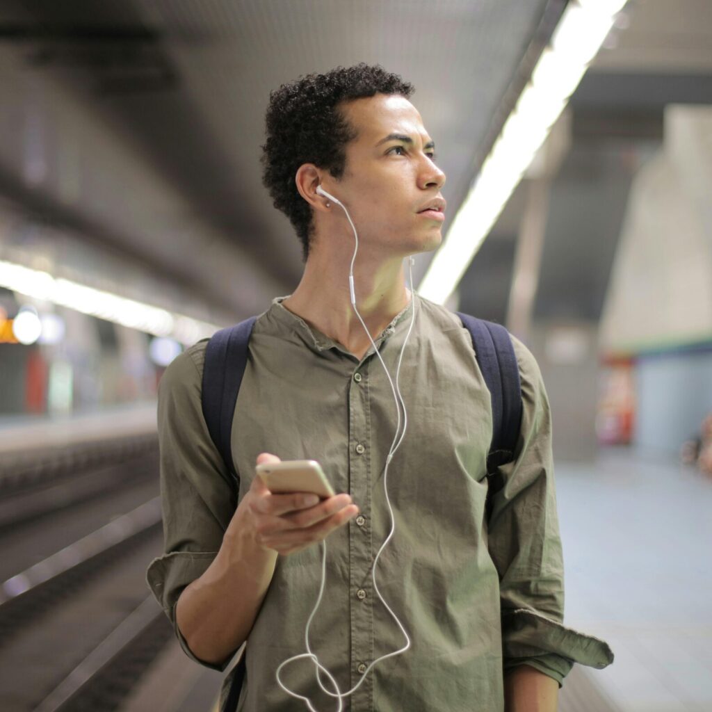 young man walking through underground station