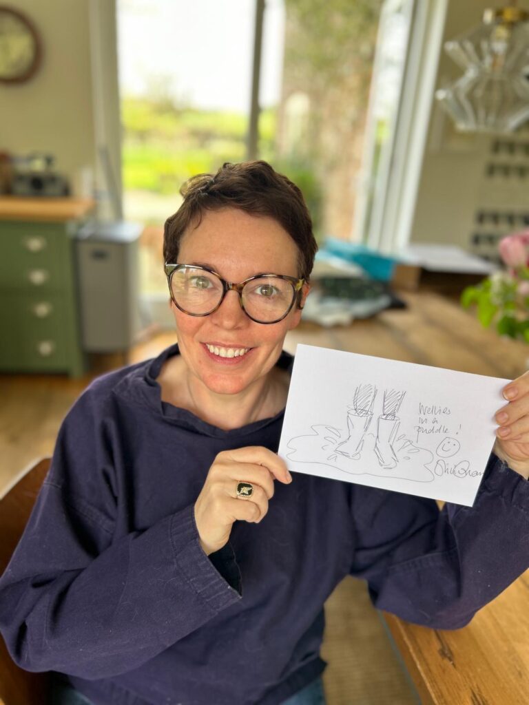 Olivia Colman holding her National Doodle Day 2024 doodle for Epilepsy Action