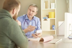 Doctor talking to male patient