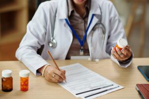 General practitioner prescribing new medicine to patient