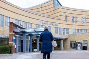 Woman walking into hospital